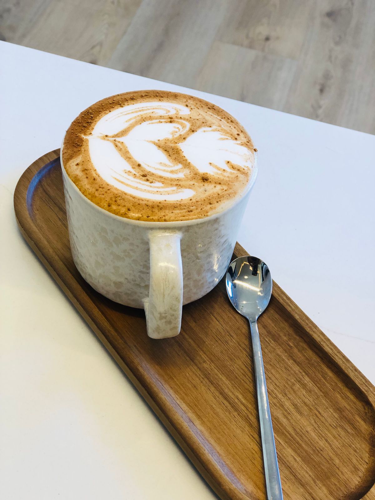 Latte with heart-shaped latte art in a Fairfield Coffee mug