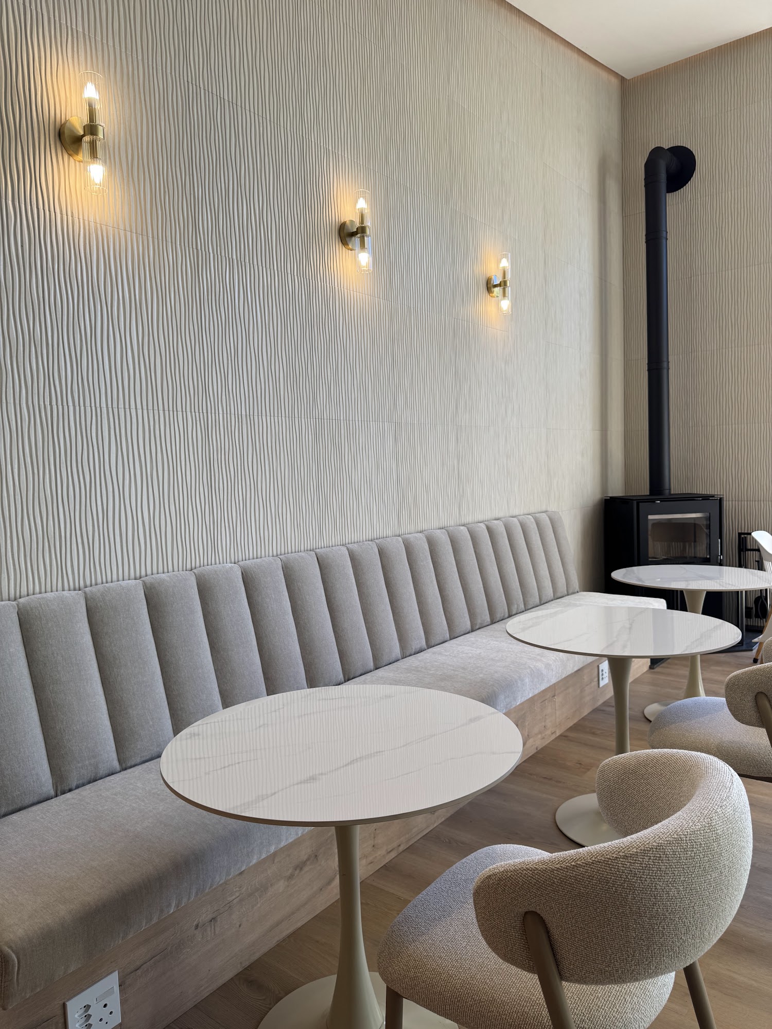 Cozy lounge seating with a wood-burning stove inside Fairfield Coffee
